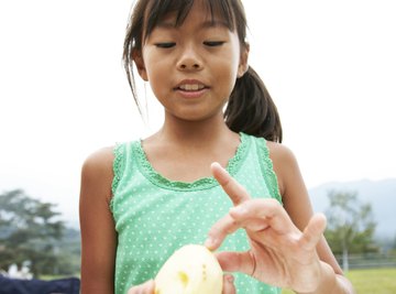 The moisture in potatoes facilitates holding a current.