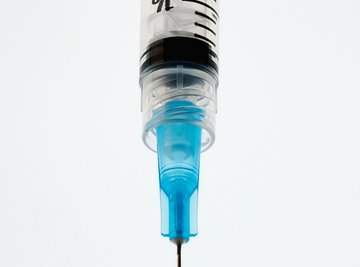 Syringes are marked in gradations of whole and fractional milliliters.