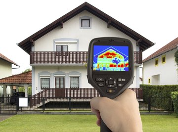 Warm spots on a house, revealed by an infrared camera, can indicate poor thermal insulation.