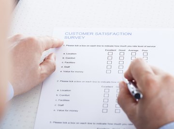 An overhead view of a man filling out a survey.