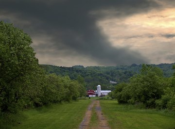 A tornado behind a farm.