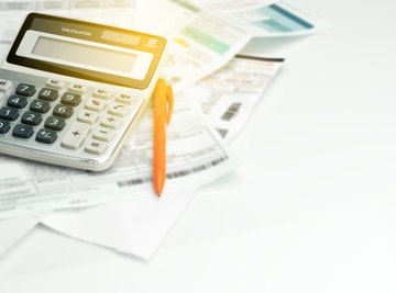 Calculator, pen and papers on a desk