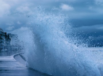 A wave hitting a curved seawall.