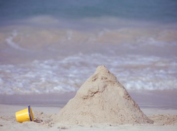 Wet sand has a higher angle of repose than dry sand. And it makes better sand castles.