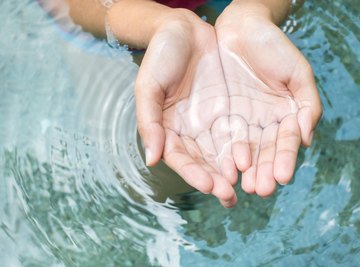 In water, dipoles form strong hydrogen bonds holding the water molecules together.