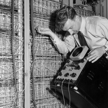 Man working on early electronic computer