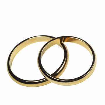 Wedding rings are worn on the right hands of the bride and groom.