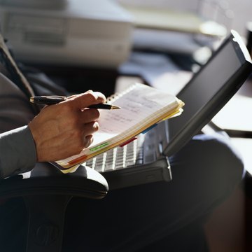 Businessman with Notebook and Laptop