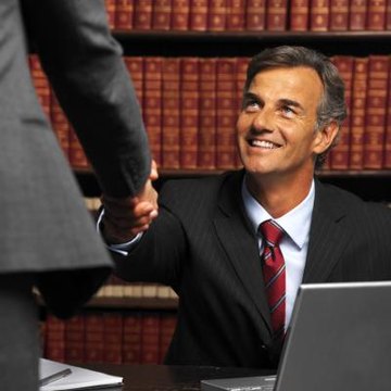 Attorney shaking hand of client.