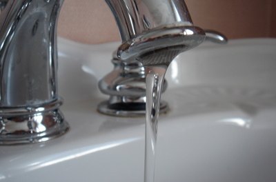 faucet image by Laura Dynan from Fotolia.com Conserve water to lower utility bills.