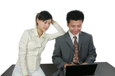 asian business people image by huaxiadragon from Fotolia.com Compare your income with your expenses before creating a budget.
