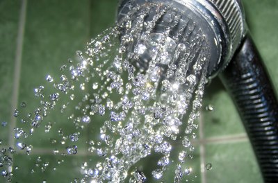 shower image by Ekaterina Shvigert from Fotolia.com Cutting back on long showers is just one of the things you can do to save money every day.