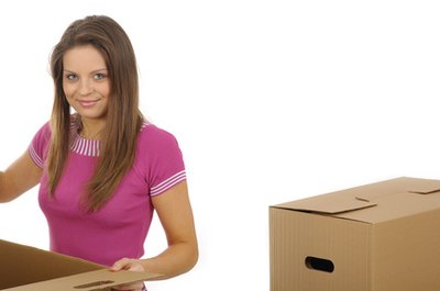 woman packing/unpacking boxes during a relocation. image by T.Tulic from Fotolia.com Keep necessities back so you can find them easily at the new house.