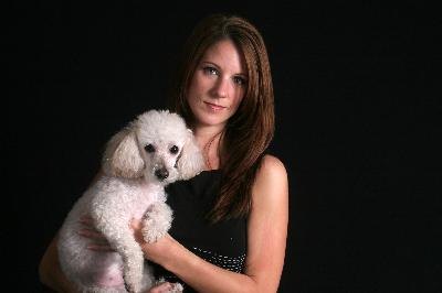 Pretty serious woman and her pet poodle image by Allen Penton from Fotolia.com Small white dogs such as poodles are prone to shaking syndrome.