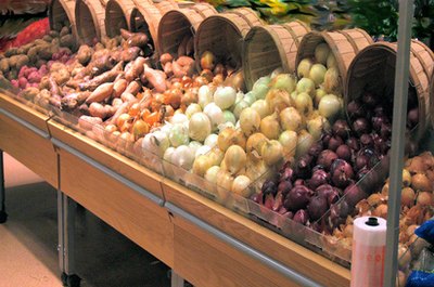 produce department image by brelsbil from Fotolia.com Buying produce in season will cut your costs.