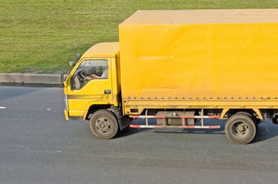 blank yellow big delivery truck on road image by alma_sacra from Fotolia.com Take the bite out of moving expenses with tax deductions.
