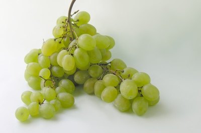 grapes image by Maria Brzostowska from Fotolia.com Grapes are toxic to dogs.