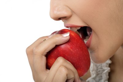 Visage/Stockbyte/Getty Images Carbohydrate digestion begins in your mouth.