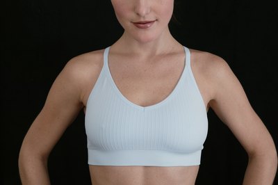 Comstock Images/Comstock/Getty Images Sports will reduce breast size, while other exercises will enhance them.
