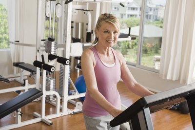 Jupiterimages/Comstock/Getty Images Whether at home or at the gym, you can boost your calories burned by increasing the incline with your walking workout.