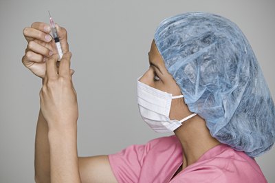 Photodisc/Photodisc/Getty Images A cath lab nurse may scrub in to assist doctors with cardiovascular surgeries.