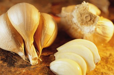 Stockbyte/Stockbyte/Getty Images Try eating fresh garlic to reduce excess mucus.