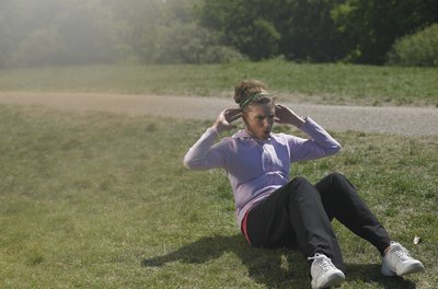 John Howard/Digital Vision/Getty Images A soft tuft of grass is ideal for an outdoor ab workout.