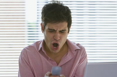 Creatas Images/Creatas/Getty Images Don't lose your cool on the phone when talking to credit card reps.
