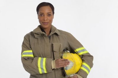 Jupiterimages/Creatas/Getty Images Firefighters must be OK with heights in order to climb tall ladders.