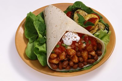 Jupiterimages/Comstock/Getty Images Beans, fatty foods and fiber contribute to gassiness.