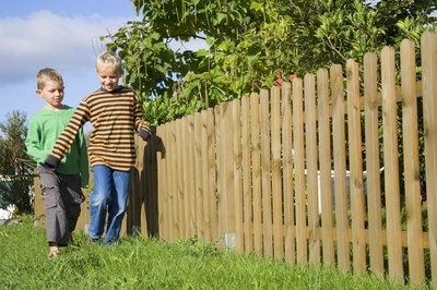 Jupiterimages/Creatas/Getty Images You can build a low-cost fence from wood pallets.