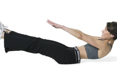 Photodisc/Photodisc/Getty Images Reverse sit-ups target the lower abdominal muscles.