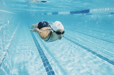 Digital Vision./Digital Vision/Getty Images Practice and proper technique will improve your swimming.