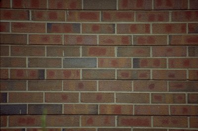 Jupiterimages/Photos.com/Getty Images Solid brick fences offer privacy and durability.