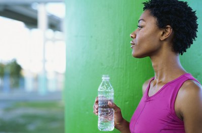 Stockbyte/Stockbyte/Getty Images For proper muscle health, hit the water bottle before hitting the gym.