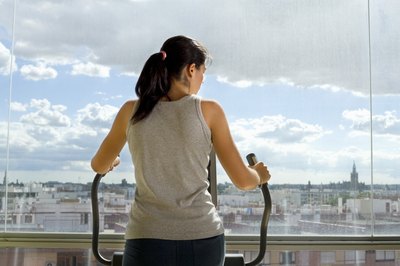 IT Stock/Polka Dot/Getty Images Owning an elliptical trainer allows you to work out at home.