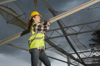 Jupiterimages/BananaStock/Getty Images Construction workers build residential, commercial and industrial structures, as well as civil infrastructure such as roads and bridges.