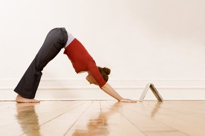 Jupiterimages/Comstock/Getty Images Downward-Facing Dog is a common transitional yoga pose.