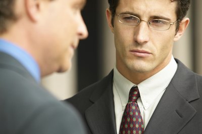 Hemera Technologies/AbleStock.com/Getty Images Insecure colleagues belittle, tattle and stir up trouble in an office.