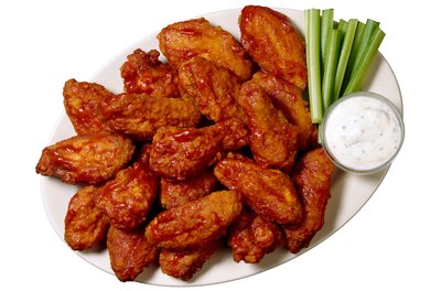 Brand X Pictures/Brand X Pictures/Getty Images Hot wings are often served with blue cheese dressing for dipping.