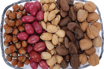 Zedcor Wholly Owned/PhotoObjects.net/Getty Images Walnuts, pecans and pistachios contain healthy fats that may help lower your cholesterol.