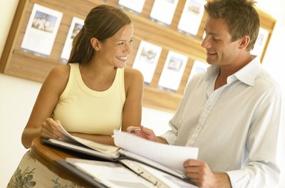 BananaStock/BananaStock/Getty Images Title companies help real estate sales run smoothly.