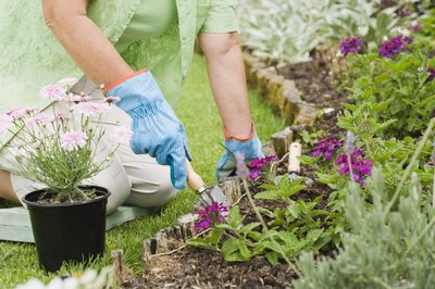 Jupiterimages/Polka Dot/Getty Images Gardening and mowing the lawn aren't deductible, but major landscaping is.