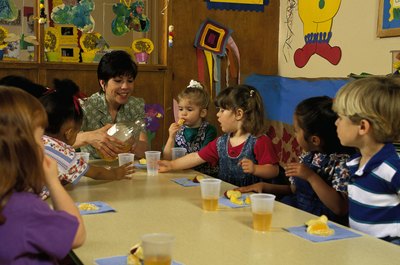 Comstock/Comstock/Getty Images Some daycare staffers provide snacks and meals to children.