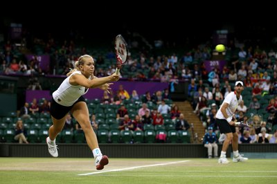 Clive Brunskill/Getty Images Sport/Getty Images Players compete in doubles on the grass courts at Wimbledon.
