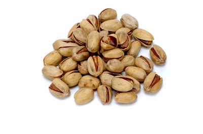 Jupiterimages/Photos.com/Getty Images Pistachios contain more vitamin E than macadamia nuts.