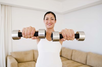 Jupiterimages/Goodshoot/Getty Images Front raises develop strength and size in your shoulders.