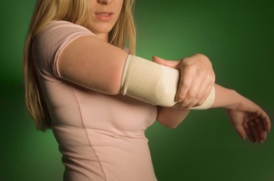 Creatas Images/Creatas/Getty Images Treat and prevent tennis elbow with stretching and strengthening exercises.