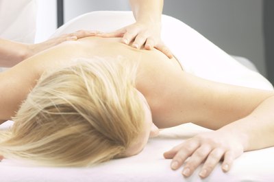 Hemera Technologies/AbleStock.com/Getty Images Massage therapists in solo practice earn an hourly wage plus tips.
