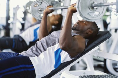 Stockbyte/Stockbyte/Getty Images Bench pressing is one way to work the chest, shoulders and arms.